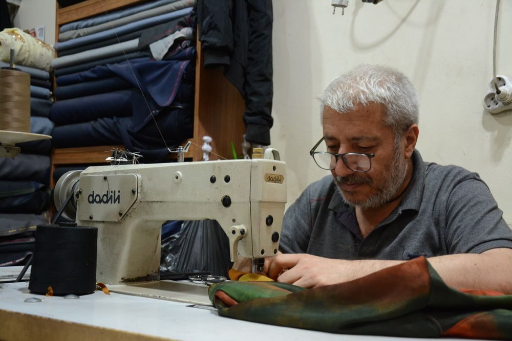 Experienced tailor working at an industrial sewing machine