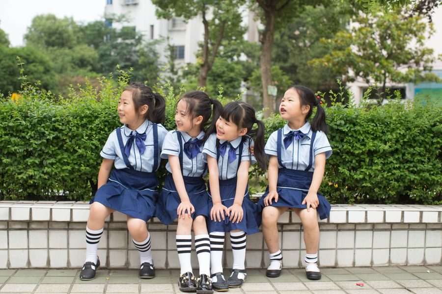 Schoolchildren in matching blue and white uniforms