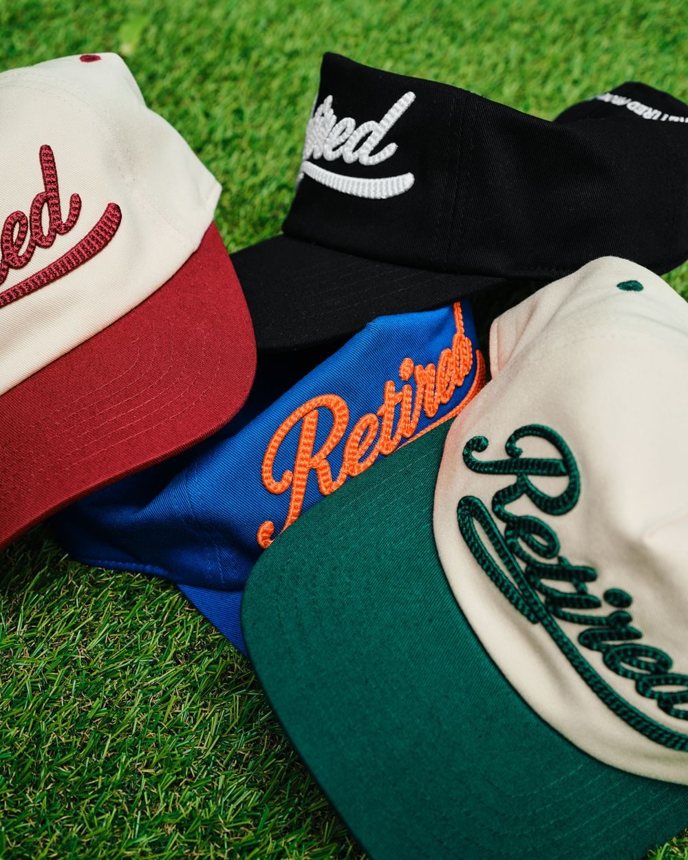 Stack of caps with embroidered script lettering