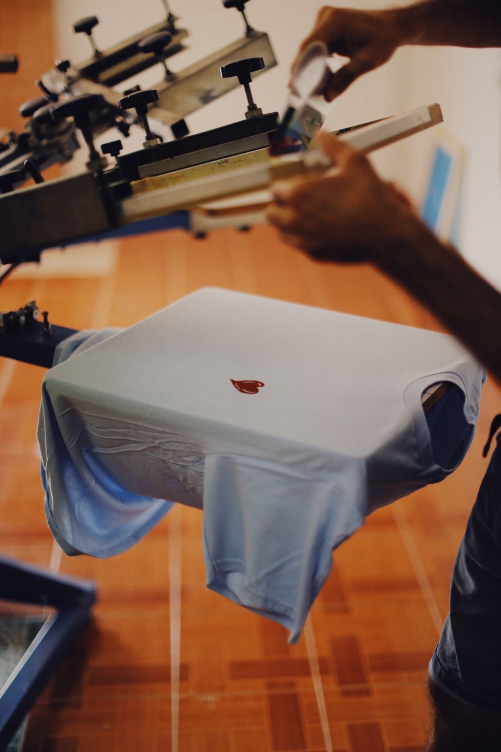 T-shirt being screen printed on a press