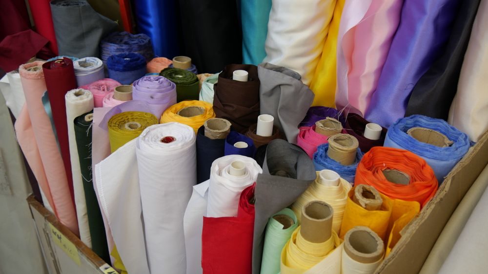 Colourful rolls of fabric stacked in a shop