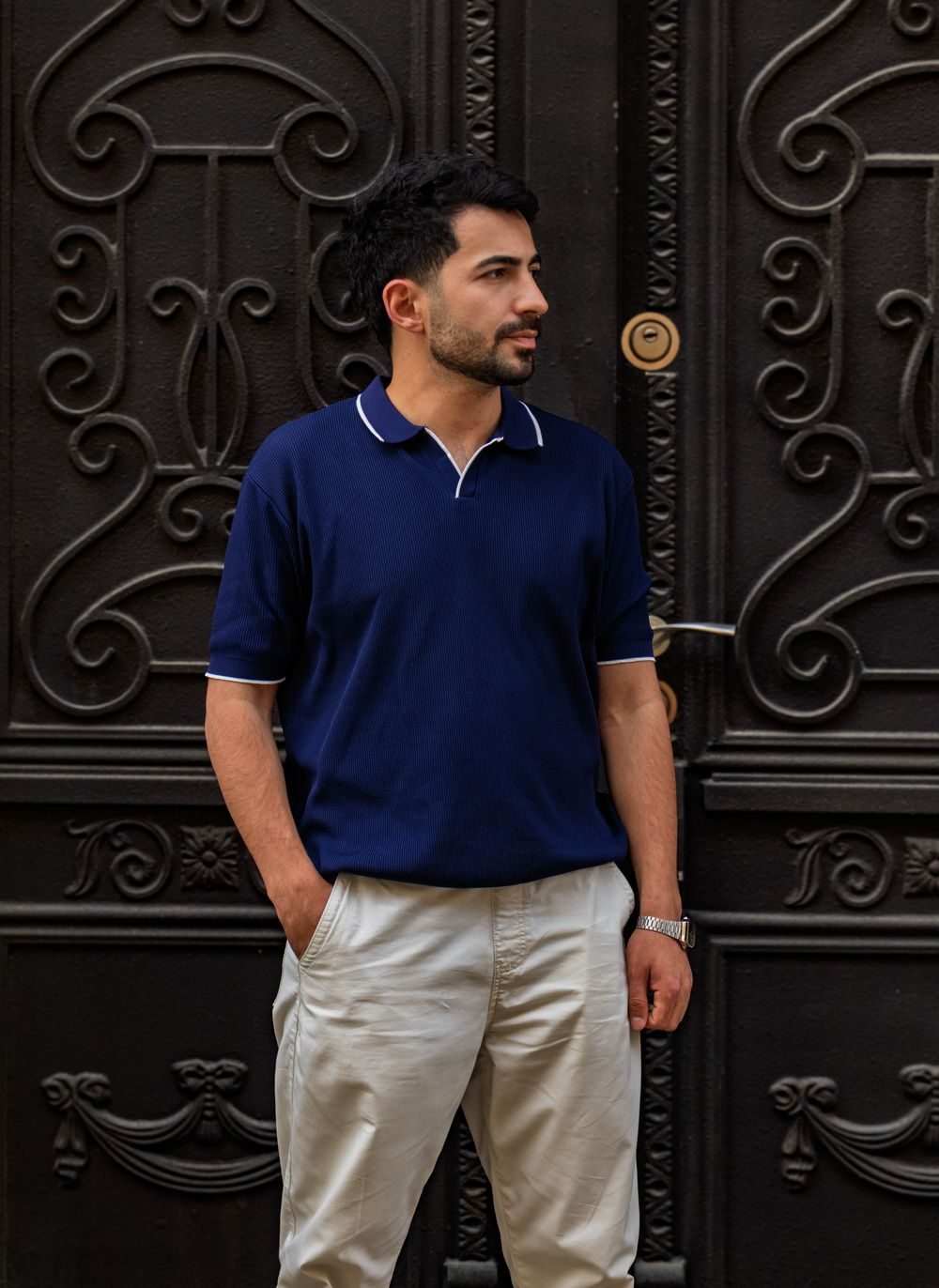 Man wearing a navy embroidered polo shirt